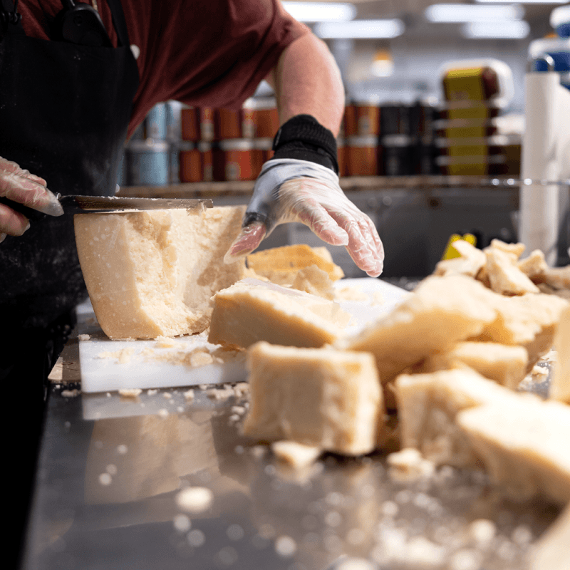 Cheesemonger cutting parmesan