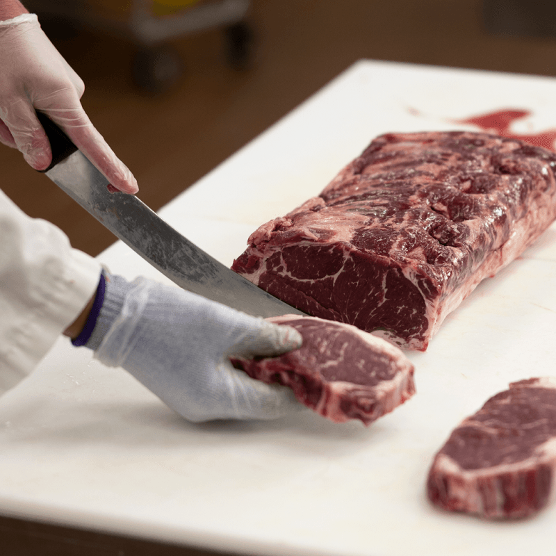 Butcher cutting steak